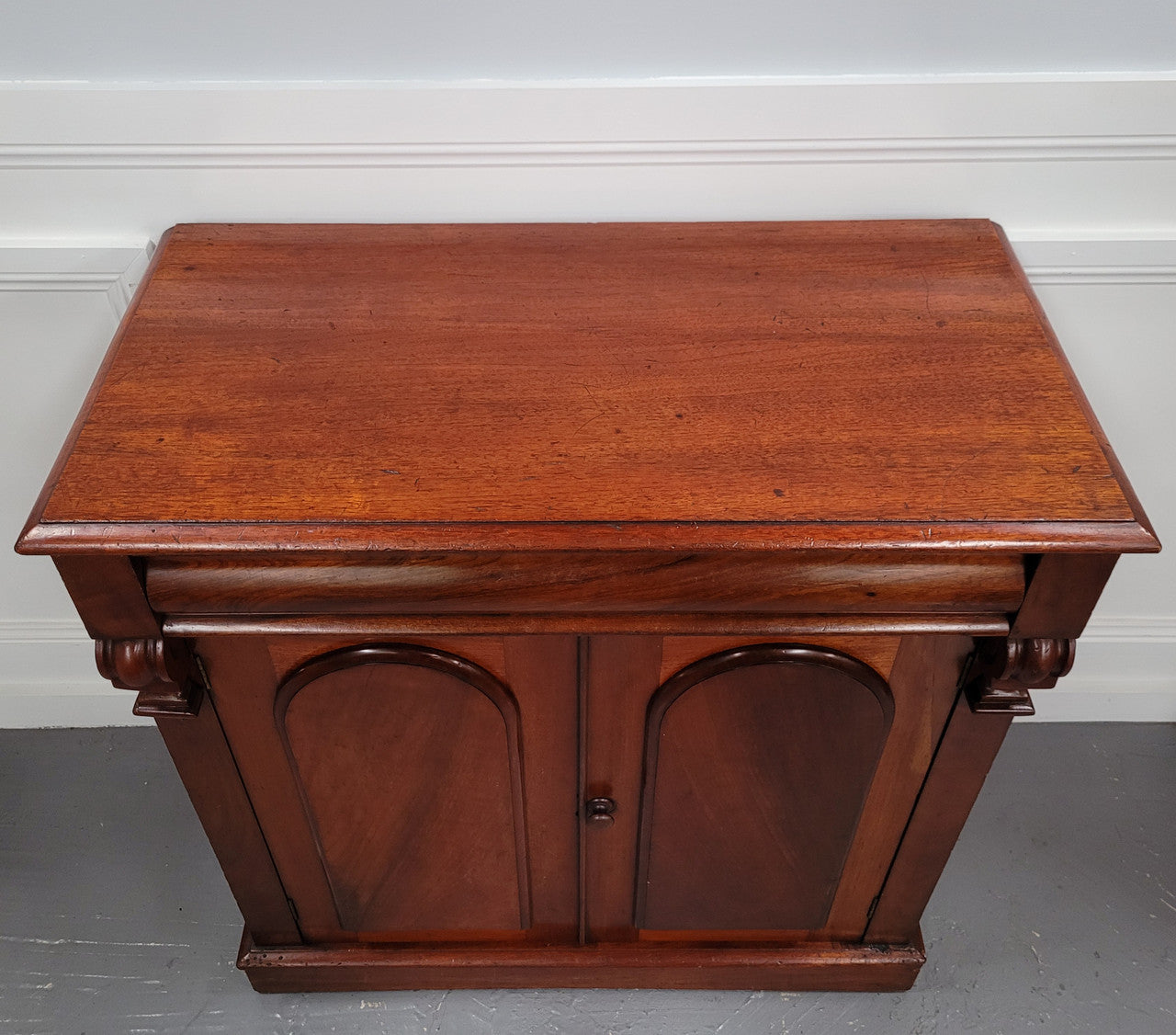 Cedar side cabinet with two doors one drawer and lovely door panels and corbels. It has been sourced locally and is in good original detailed condition.