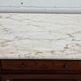 Fabulous French Walnut Louis XVI style cupboard, with a lovely marble top and nine drawers. There is also a cupboard and beautiful ormolu mounts. It is in good original detailed condition.