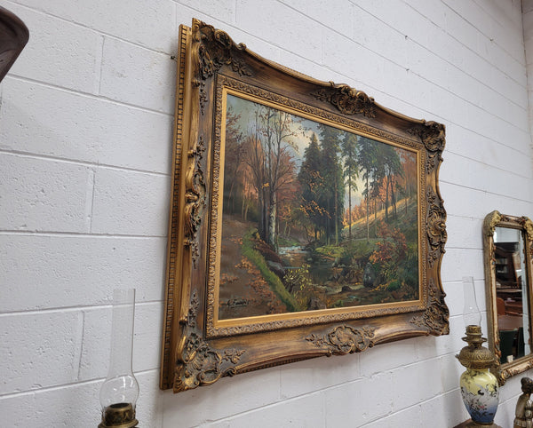 Large signed oil on canvas depicting a river stream in autumn framed in a stunning gilt frame. Sourced from France and is in good original detailed condition.