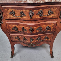 Antique French Louis XV style compact three drawer marble top commode with marquetry inlay and ormolu mounts. Sourced from France and in good original detailed condition.