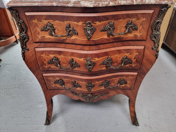 Antique French Louis XV style compact three drawer marble top commode with marquetry inlay and ormolu mounts. Sourced from France and in good original detailed condition.