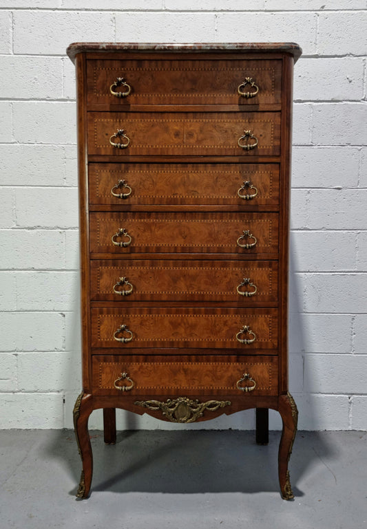 Louis XV style parquetry inlaid marble top semainier. It has seven drawers and a stunning coloured marble top. In good original condition.