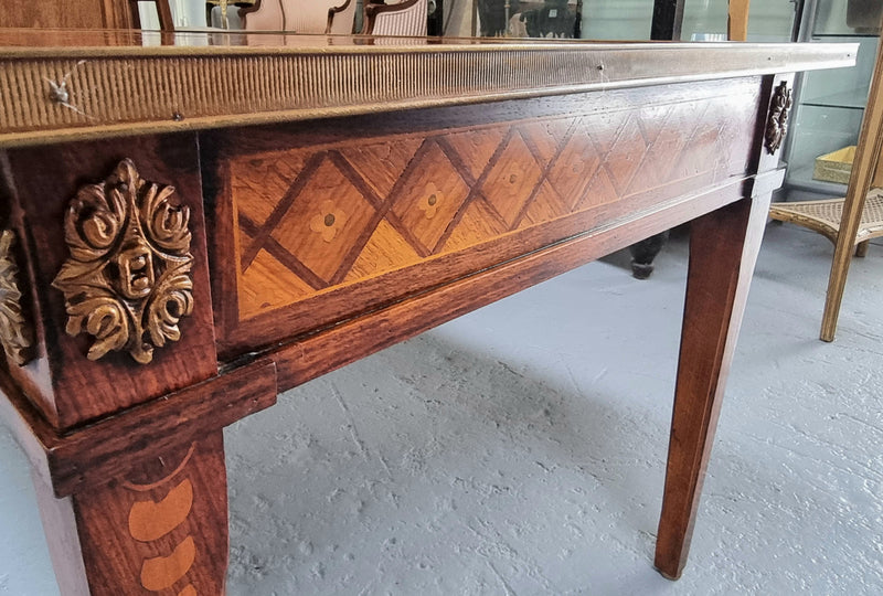 Beautiful French Louis XVI style inlaid coffee table with a brass band and glass top. In good original detailed condition.