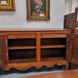 Early 19th Century Louis XV style Fruitwood three door sideboard. It has three hidden internal drawers and one of them has green valet and small sections for cutlery. It is in good restored condition.
