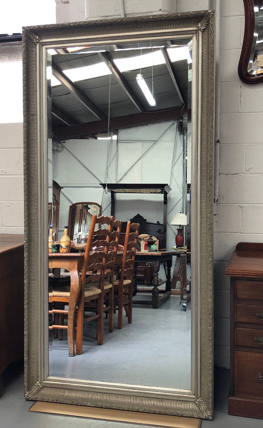 Beautiful Vintage French style silver gilt mirror of large proportions. This beautiful mirror could be used a freestanding floor mirror or it has a wire so it can be hung up on wall as well. It is in good original condition.