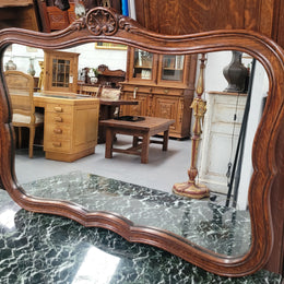 French Louis XV style carved Oak wall mirror. It is in good original detailed condition and has been sourced from France.