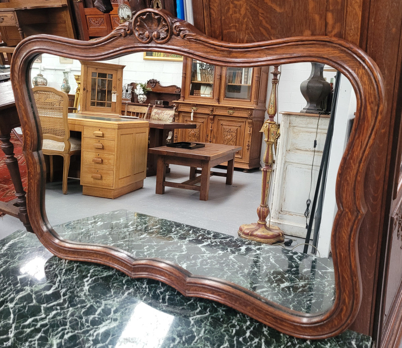 French Louis XV style carved Oak wall mirror. It is in good original detailed condition and has been sourced from France.